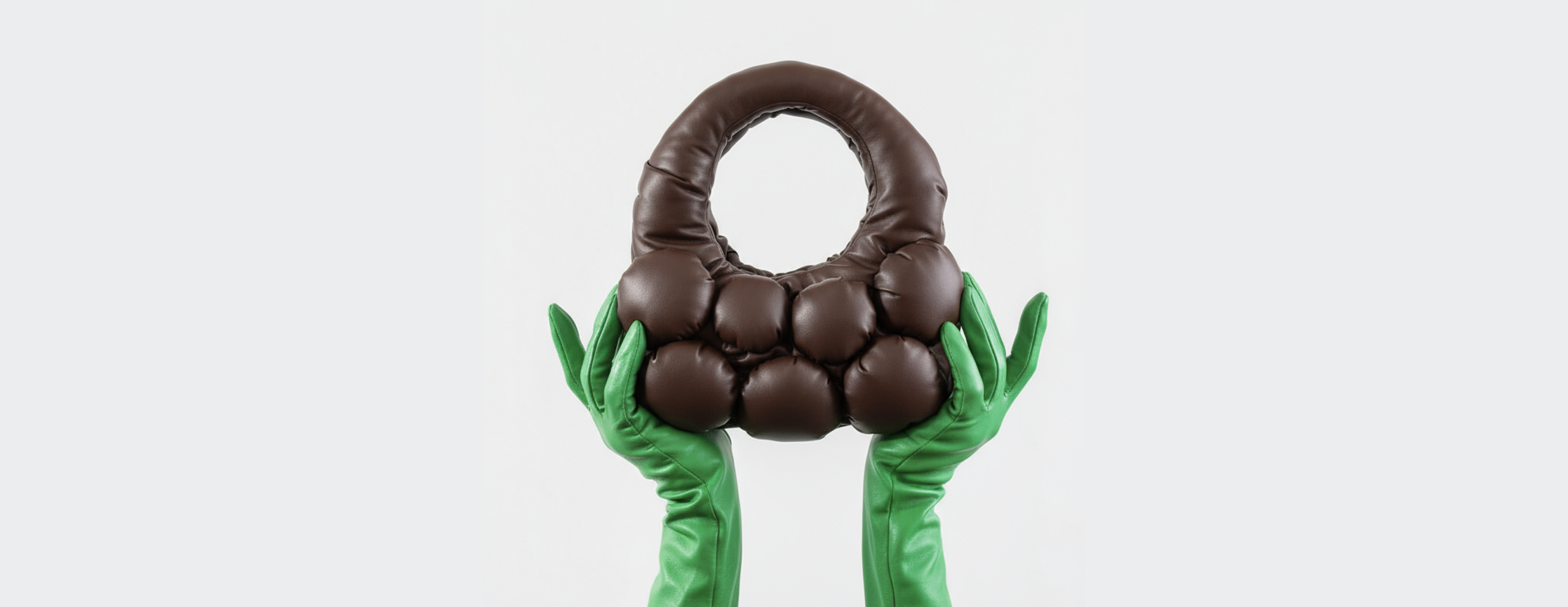 Chocolate bag held by green gloves on a white background
